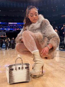 Jordyn Woods Courtside in Fur with an Hermes Himalayan Birkin and Dsquared2 Stiletto Boots