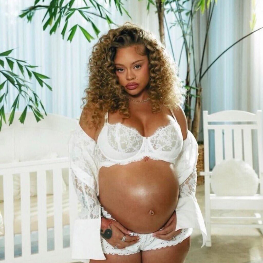 Latto Debuts Baby Bump in White Lace Lingerie and Polka Dot Set in “Business and Personal (Intro)” Video